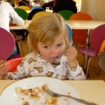 child eating seafood
