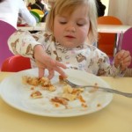 child eating seafood